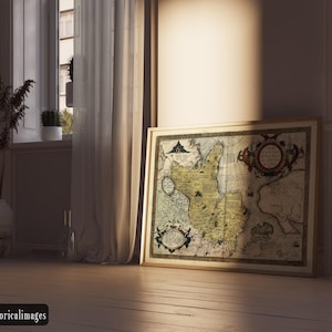 May include: A framed antique map with a detailed cartographic design, featuring intricate details and a vintage aesthetic. The map is displayed on a wooden floor, leaning against a wall near a window with sheer curtains. The image includes the text "historicalimages".
