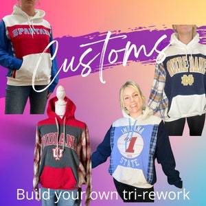 May include: Three custom-made hoodies with different designs. The first hoodie is white with red and blue panels and the text "SPARTAN" on the front. The second hoodie is white with blue and plaid panels and the text "INDIANA STATE" on the front. The third hoodie is white with blue and plaid panels and the text "NOTRE DAME" on the front.
