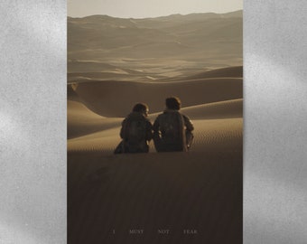 May include: Two figures sit facing away from the camera on a sand dune in a desert landscape. The sky is a pale orange and the sand is a warm brown. The text "I MUST NOT FEAR" is printed at the bottom of the image.