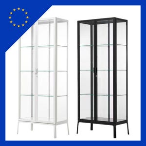 May include: Two glass display cabinets, one white and one black, with glass shelves and doors. The cabinets have a modern design with a rectangular shape, suitable for displaying collectibles. Each cabinet is approximately 180 cm tall.