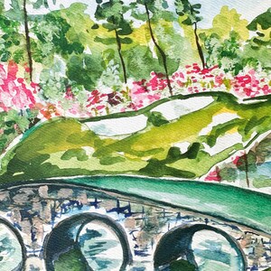 May include: Watercolor painting of a stone bridge with three arches over a green grassy area. The bridge is painted in shades of green, brown, and gray. The grassy area is painted in shades of green and yellow. There are trees in the background, painted in shades of green and blue.
