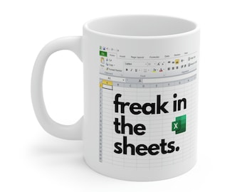 May include: White ceramic mug with a black and green design. The design features a spreadsheet with the text "freak in the sheets."