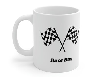 May include: White ceramic coffee mug with a black and white chequered flag design and the text "Race Day".