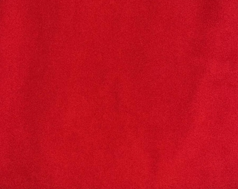 Peut inclure: Un échantillon de tissu rouge uni. Le tissu a une texture douce et duveteuse.