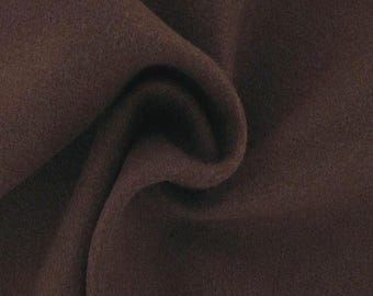 May include: A close-up of a dark brown fabric with a soft, textured surface. The fabric is folded and draped, showing its smooth, even texture.