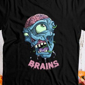Puede incluir: Camiseta negra con una ilustración de zombie azul y rosa y el texto "BRAINS".