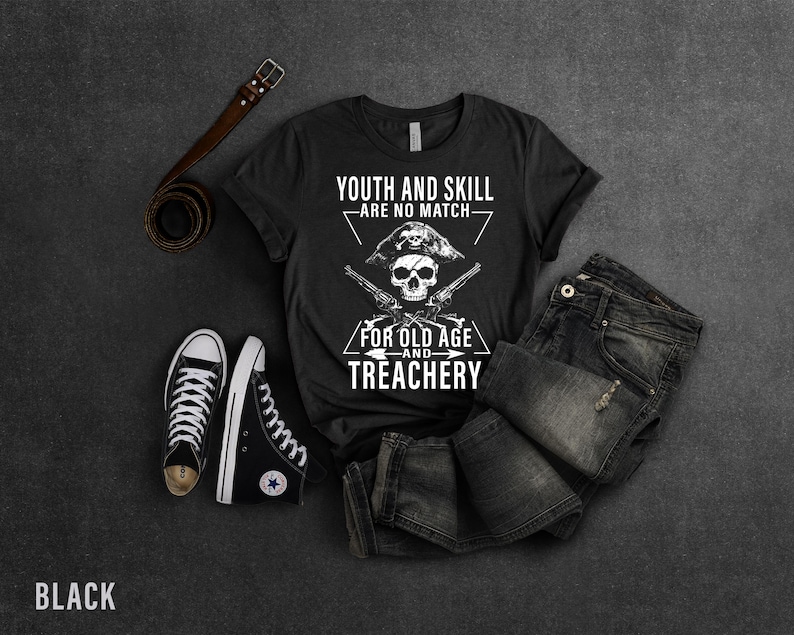 May include: Black t-shirt with a white skull and crossbones graphic. The text reads "Youth and skill are no match for old age and treachery".