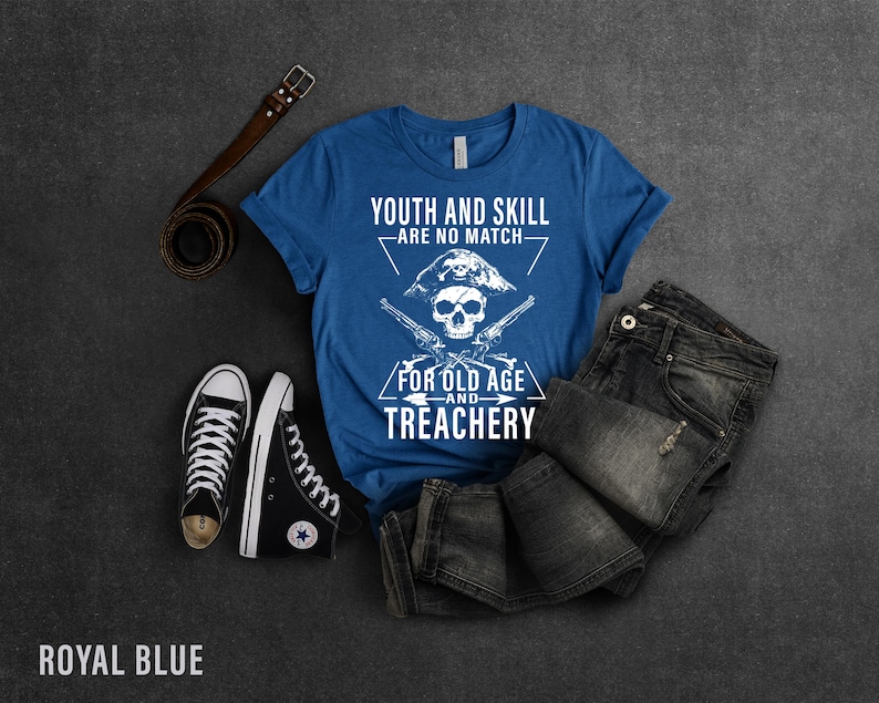 May include: Royal blue t-shirt with a white skull and crossbones graphic. The text on the shirt reads "Youth and Skill Are No Match For Old Age and Treachery".