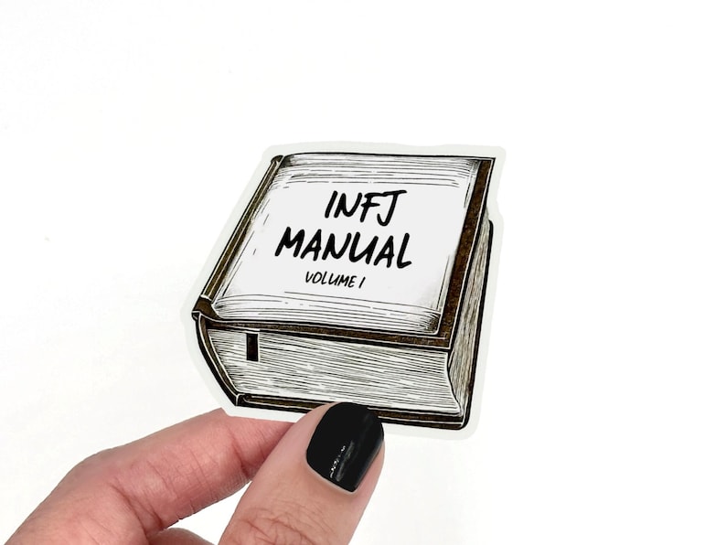 May include: A sticker of a book with the text "INFJ MANUAL VOLUME I" on the cover.