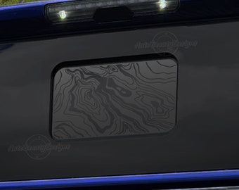 May include: Black truck tailgate with a black and gray patterned window overlay. The overlay has a wood grain design. The text "Auto Beauty Designs" is visible in the image.