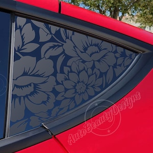 May include: A black floral design car window decal with the text "AutoBeautyDesigns" in white.