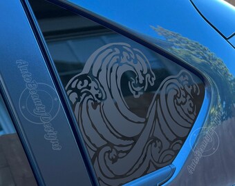 May include: A black and white wave design car window decal. The decal is applied to the rear passenger side window of a blue car.