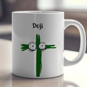 May include: White ceramic mug with a green cross design featuring cartoon eyes and the word "Doji" in black. The mug has a curved handle and is suitable for hot or cold beverages.