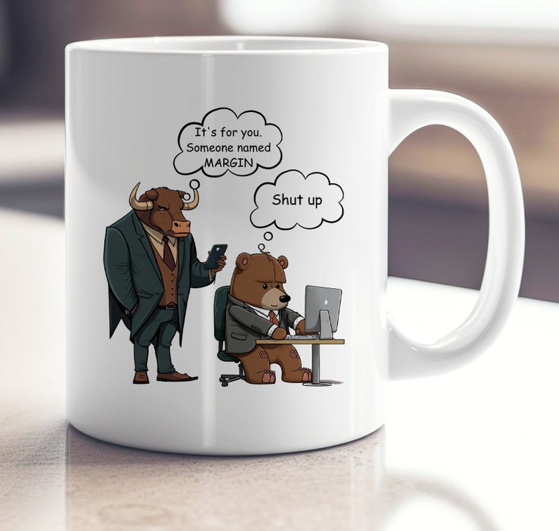 May include: White ceramic mug with a cartoon bull and bear illustration. The bull is wearing a suit and tie and is holding a phone. The bear is wearing a suit and tie and is sitting at a desk with a computer. The text on the mug reads "It's for you. Someone named MARGIN. Shut up."