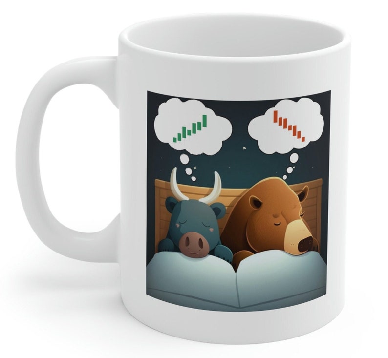 May include: White ceramic mug with a cartoon illustration of a bull and a bear sleeping in a bed. The bull is dreaming of a green upward stock chart and the bear is dreaming of a red downward stock chart.