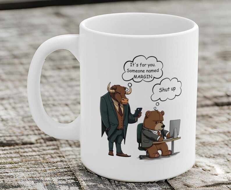 May include: White ceramic mug with a cartoon illustration of a bull in a suit and a bear in a suit. The bull is saying "It's for you. Someone named MARGIN." The bear is at a computer and has a thought bubble above its head that says "Shut up."