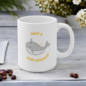 May include: White ceramic mug with a gray whale illustration and the text "Have a good morning!" in yellow.