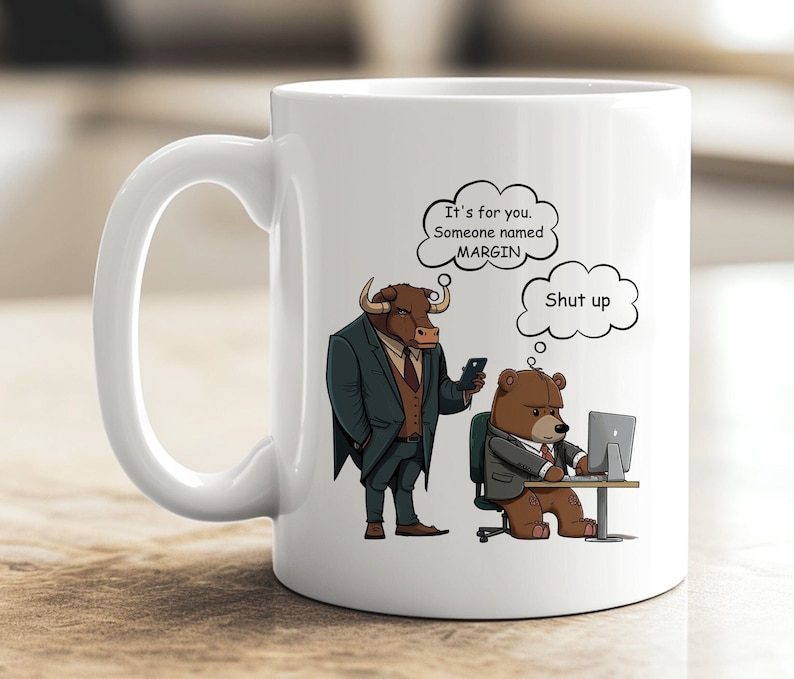 May include: White ceramic mug with a cartoon bull wearing a suit and a bear wearing a suit and using a computer. The bull has a thought bubble above its head that says "It's for you. Someone named MARGIN." The bear has a thought bubble above its head that says "Shut up."