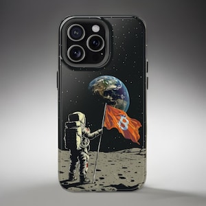 May include: A black iPhone case with a space-themed design. An astronaut stands on the moon holding a flag with a Bitcoin symbol. The Earth is visible in the background.