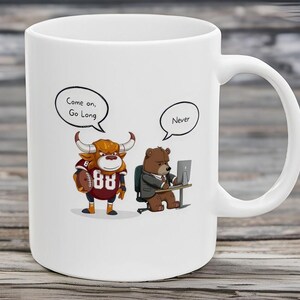 May include: White ceramic coffee mug with a cartoon bull and bear illustration. The bull is wearing a football jersey with the number 88 and holding a football. The bear is wearing a suit and sitting at a desk with a computer. The bull's speech bubble says "Come on, Go Long" and the bear's speech bubble says "Never".
