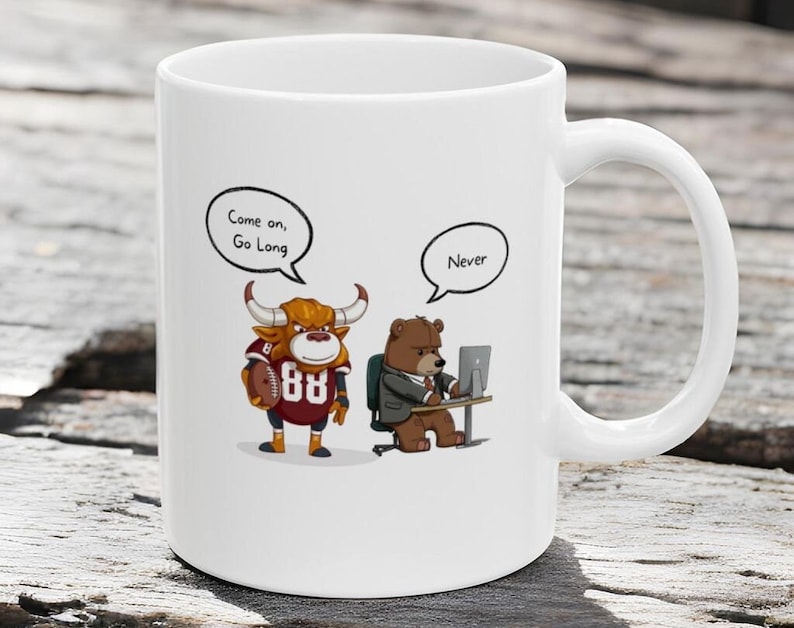 May include: White ceramic coffee mug with a cartoon bull wearing a football jersey and holding a football. The bull is saying "Come on, Go Long". A cartoon bear wearing a suit is sitting at a desk with a computer and saying "Never".