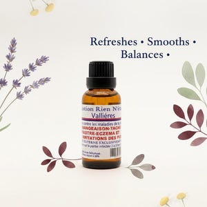 May include: A brown glass bottle with a black cap, labeled "Lotion Rien N'&eacute;t Valli&eacute;res." The label includes text in French. The image is decorated with floral and leaf illustrations, and the words "Refreshes, Smooths, Balances" are displayed.