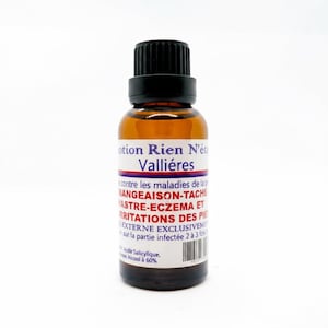 May include: A brown glass bottle with a black cap and a white label. The label has text in French, including "otion Rien N'&eacute;t Valli&eacute;res" and other descriptive text. The bottle is on a white background.