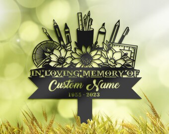 May include: Black metal memorial garden stake with a design of art supplies and sunflowers. The stake has a sign that reads "In Loving Memory of Custom Name 1955 - 2023".
