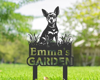 May include: Black metal garden sign with a silhouette of a chihuahua sitting on a bed of grass. The sign reads "Emma's Garden".