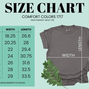 The image is a size chart for a heavyweight adult t-shirt, providing measurements for different sizes. The chart includes a table with size categories (S, M, L, XL, 2XL, and 4XL) and corresponding width measurements in inches. The t-shirt is displayed next to the chart, and there is a plant leaf on the right side of the image.