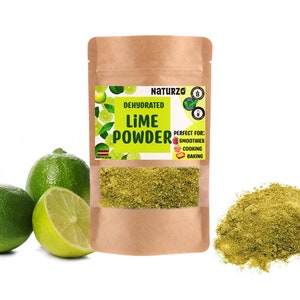 May include: A brown paper bag with a label that reads "Dehydrated Lime Powder" and "Perfect for: Smoothies, Cooking, Baking". The bag is filled with green lime powder. There are three limes next to the bag, two whole and one cut in half.