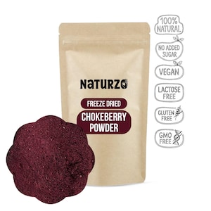 May include: A package of Naturzo freeze-dried chokeberry powder. The package is a light brown color with the Naturzo logo and product information in white and burgundy. A portion of the powder is displayed next to the package. The package also has labels indicating the product is 100% natural, vegan, and gluten-free.