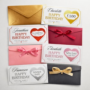 May include: A collection of gift cards and envelopes in various colors. The cards feature birthday greetings and scratch-to-reveal areas for experiences like glamping, spa days, and dinner dates. Envelopes are gold, red, pink, and black.