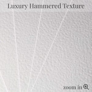 May include: Close-up of white paper with a hammered texture. The paper is fanned out, revealing the textured surface. The words "Luxury Hammered Texture" are at the top, and "zoom in" is at the bottom.