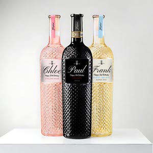 May include: Three bottles of wine with personalized labels. The bottles are a pink rose, a red merlot, and a white pinot grigio. Each bottle has a different name and birthday message on the label.