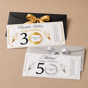May include: Two rectangular gift tickets with envelopes. One ticket features gold accents, the number 30, and a scratch-off circle labelled Afternoon Tea. The other features silver accents, the number 50, and a scratch-off circle labelled Glamping for 2.