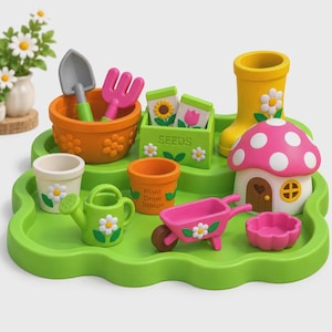 May include: A green plastic tray holding a collection of toy gardening items including an orange bowl with a shovel and rake, a green seed box, a yellow boot, a mushroom house, a white pot, an orange pot, a green watering can, and a wheelbarrow.