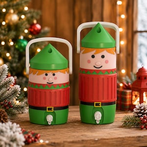 May include: Two cylindrical beverage dispensers designed to resemble elves, each featuring a green pointed hat lid, a white handle, a light pink face with simple facial features, a red ribbed sweater section, and a green base with a white spigot.