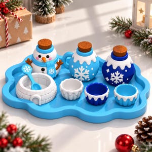 May include: A blue cloud-shaped tray holding a snowman-shaped container, two round containers with cork stoppers, an igloo-shaped bowl with a small blue spoon, and three small scalloped cups in shades of white and blue with snowflake patterns.
