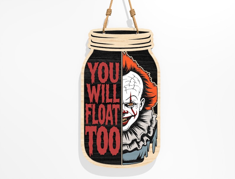 Puede incluir: Cartel de madera con forma de tarro con el texto "YOU WILL FLOAT TOO" en rojo. El lado derecho presenta un gr&aacute;fico de un payaso aterrador con pelo rojo y maquillaje blanco. El cartel cuelga de una cuerda de yute.