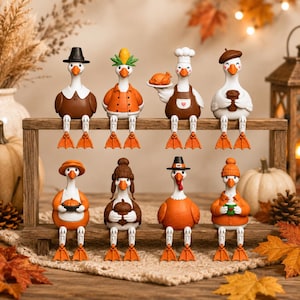 May include: A set of eight white goose figurines with orange webbed feet, arranged on a wooden shelf. Each goose wears different seasonal attire, including hats, scarves, and aprons, while holding items like a pie, acorn, coffee cup, or turkey.
