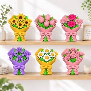 May include: Six decorative flower bouquet ornaments arranged on two shelves. The collection includes sunflowers, tulips, pink carnations, purple irises, white daisies, and pink roses, each wrapped in a matching coloured paper with a bow.