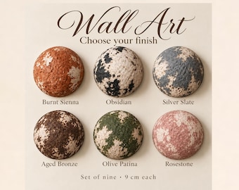 May include: Wall Art Choose your finish. Six circular textured objects in Burnt Sienna, Obsidian, Silver Slate, Aged Bronze, Olive Patina, and Rosestone. Text reads: Set of nine, 9 cm each. These round pieces feature mottled color patterns.