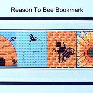 May include: A cross-stitch bookmark with the text "Reason To Bee Bookmark". The bookmark features four panels: a beehive, a bee flying, a honeycomb with a bee, and a sunflower with a bee.