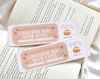 May include: Two light pink tickets with the text "CINNAMON BUN BOOK STORE" and "you're invited to the opening of the". Each ticket has a cinnamon roll graphic and the phrase "all it takes is a little sugar & spice".