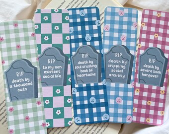 May include: A set of five rectangular bookmarks with a gingham pattern in green, pink, and blue. Each bookmark features a tombstone graphic with the text "RIP" and a humorous phrase about modern struggles.