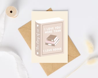 May include: A greeting card with a beige background and a brown envelope. The card features a book illustration with the text "I LOVE YOU MORE THAN I LOVE BOOKS." The spine of the book reads "the story of us."