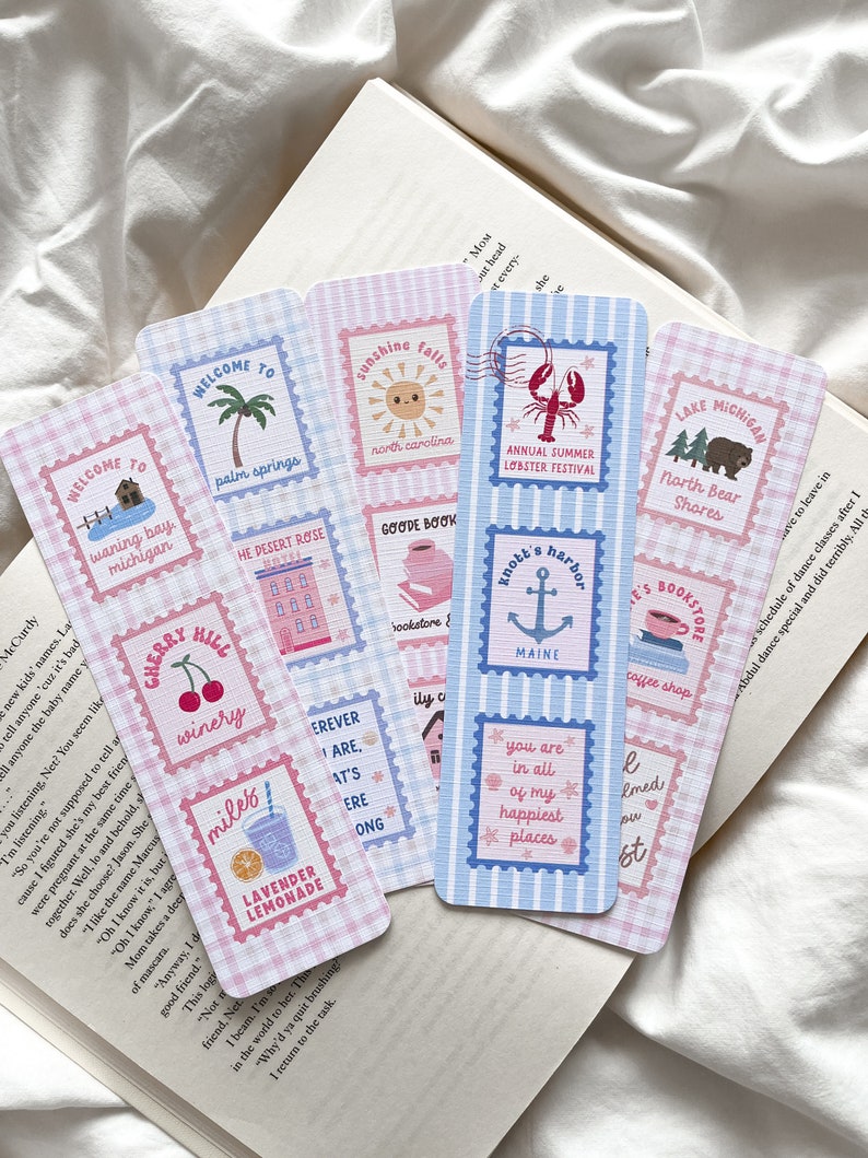 May include: A collection of decorative bookmarks with a travel theme. Each bookmark features a unique design, including illustrations of a palm tree, a sun, a lobster, and a cherry. The bookmarks have a postage stamp design with a gingham and striped background.