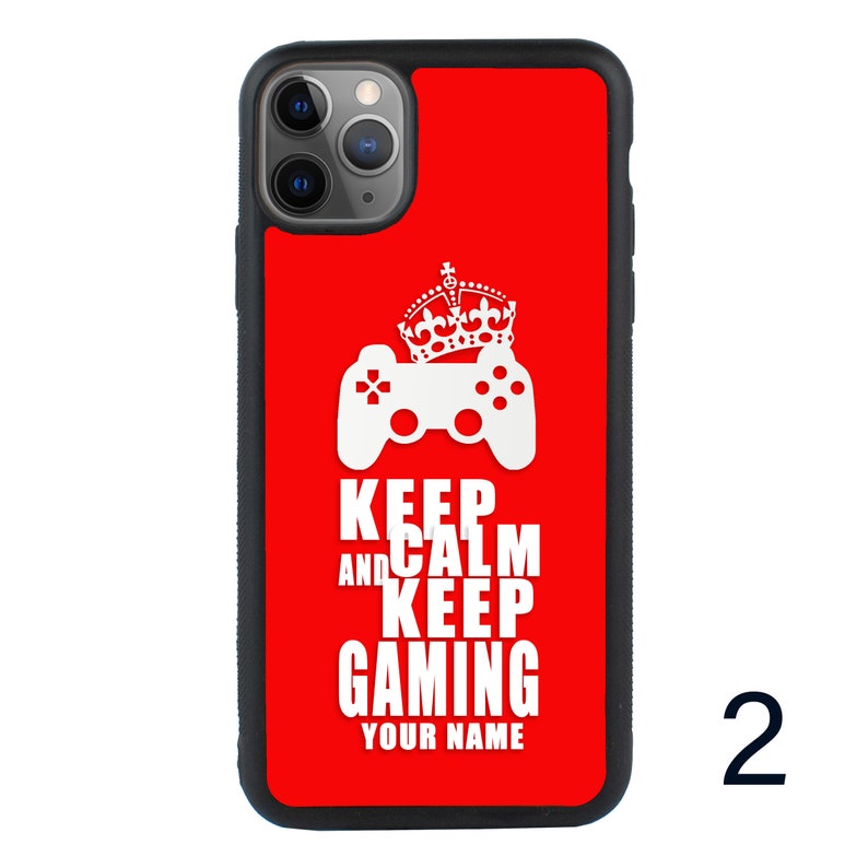 May include: Red iPhone case with a white gamepad and crown graphic. The text "Keep Calm and Keep Gaming" is printed on the case.