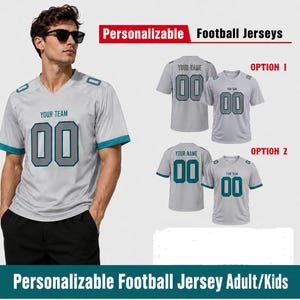 May include: A light gray short-sleeved football jersey with teal trim on the sleeves and V-neck collar. The front features the text YOUR TEAM and the number 00 in gray with teal outlines. The image displays two design options for customization.